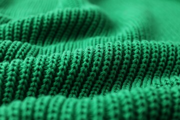 Texture of green knitted fabric as background, closeup