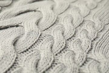 Texture of grey knitted fabric as background, closeup