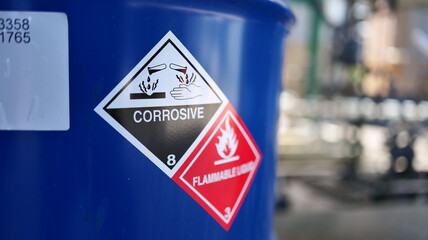 Corrosive warning sign label and flammable liquid warning sign label on the barrel tank. To warn...