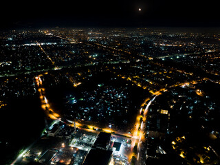 Aerial view of the city in the night, a full moon rises in the back. Islamabad, Islamabad Capital...