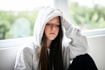 Teen girl on white studio wearing hoodies