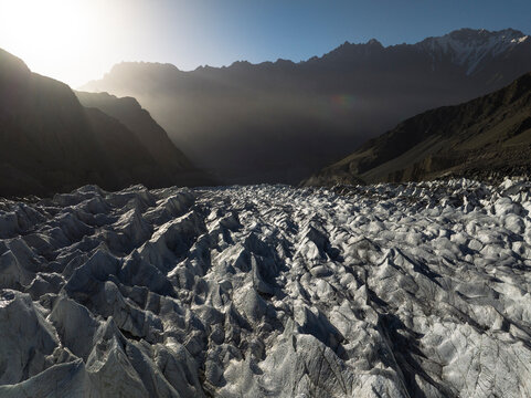 Aerial view of of sunrising over white glacier, ts Passu Glacier in the District of Hunza in the Karakoram mountains of Northern Pakistan, Himalayas.