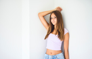 portrait of a 14 years old teen girl close to a window