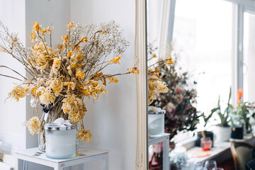 Dried flowers bouquet with a scented candle, rustic home decor, minimalist interior design, vintage aesthetic, calming atmosphere, home fragrance, dried floral arrangement