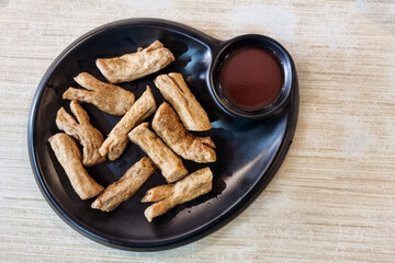 Serving of authentic fried keropok lekor, popular traditional snack among locals in Kuala Terengganu in Malaysia