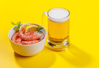 A vibrant photo showcasing a glass of beer and fresh shrimps