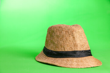 straw hat on green background. Straw hat concept. Vintage concept. space for text.