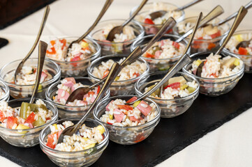 Small glass bowls with rice salad arranged on catering table