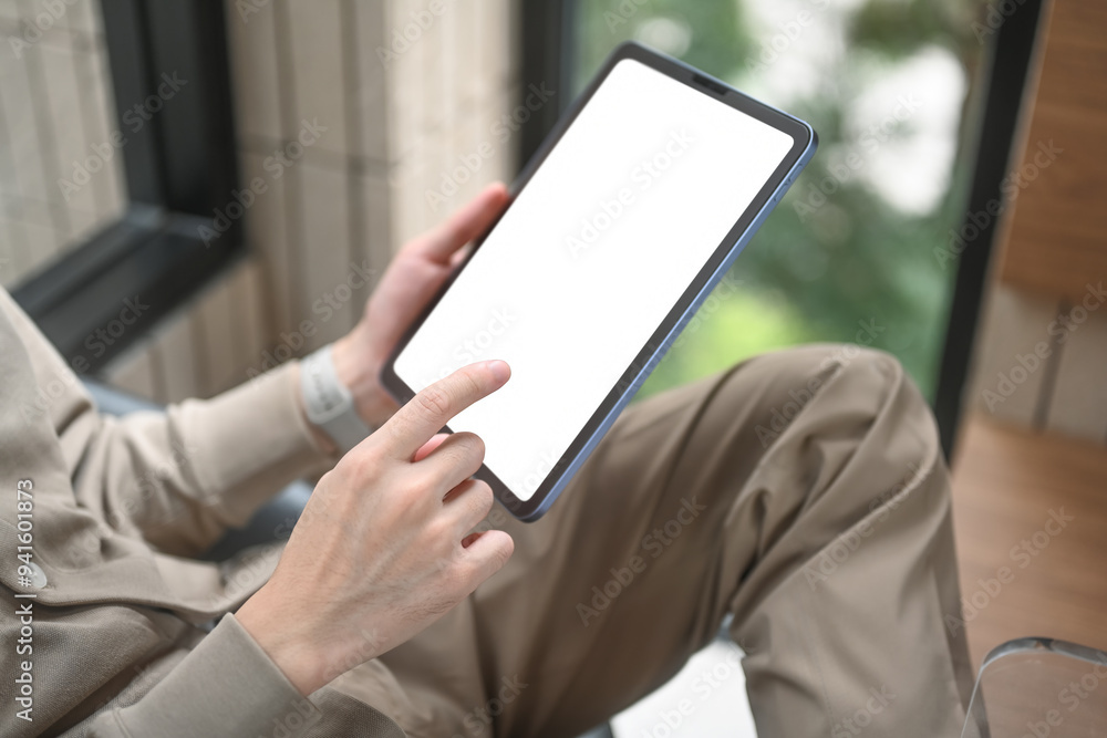 Poster close-up of a person using a tablet with a blank screen, emphasizing the potential for digital creat