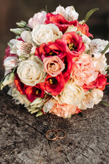 A bouquet of flowers with a ring on top of it
