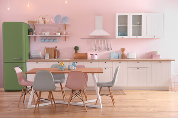 Green refrigerator in kitchen. Bright color accent in interior