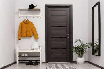Stylish hallway with mirror and shoe storage bench. Interior design