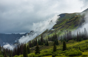 Clouds rolling up mountain in the early morning