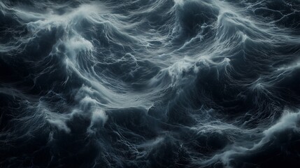 Top-down view of ocean with a dark teal and black color waves.