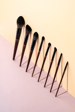 Elegant Makeup Brushes on Two-Tone Background