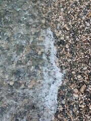 Beach pebbles top view ground.