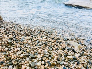 Beach pebbles top view ground.