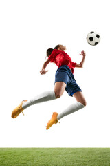 Tall female soccer player leaping in mid air to hitting ball with chest or head on stadium isolated...