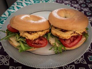 Chicken Bagel Sandwiches with Arugula and Tomato on Dotted Plate