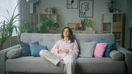 Woman relaxing on comfortable sofa in stylish