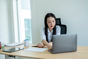 Businesswoman working with laptop in modern office