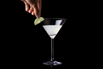 lemon slice is being picked up from a Margarita.