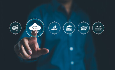 Reduce CO2 emission concept. A person touches CO2 emissions reduction symbol, representing carbon footprint awareness, net zero, and carbon neutrality. Climate change, Global warming, Greenhouse gas,