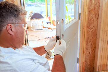 Lock doorknob installation by locksmith using screwdriver