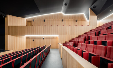 Modern auditorium with stylish interior and red seats
