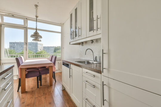 Modern kitchen interior with dining area and city view