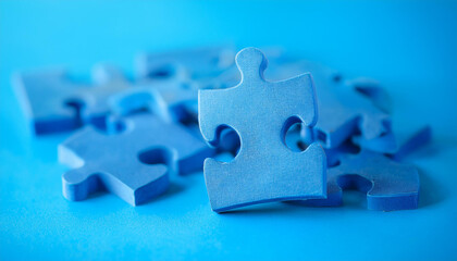 Group of blue puzzle jigsaw pieces on blue background. Business, connection and interaction