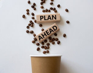 Plan ahead symbol. Wooden blocks with words Plan ahead. Beautiful white background with coffee cup and coffee beans. Business and Plan ahead concept. Copy space.