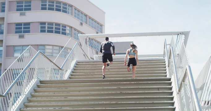 Running, city fitness and people high five on stairs of success, teamwork and workout goals, yes and support. Personal trainer, couple of friends or runner celebration for exercise race or motivation