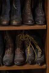 Old fashioned shoes and boots on shelves
