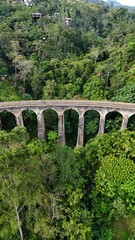 Fototapeta premium The Nine Arch Bridge. Old bridge in the mountains. Drone view. Ella, Sri Lanka.