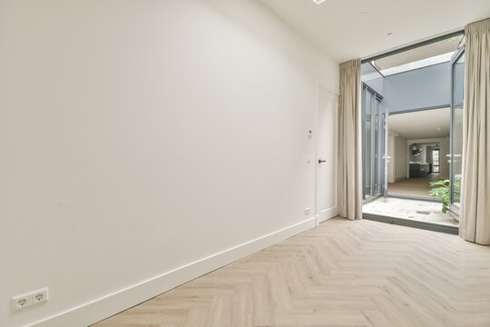 Spacious and modern empty room with herringbone floor