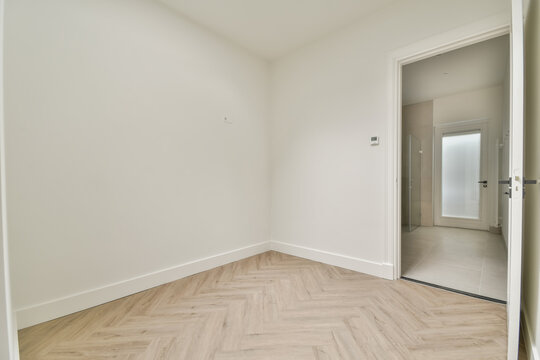 Empty room with herringbone pattern wooden floor