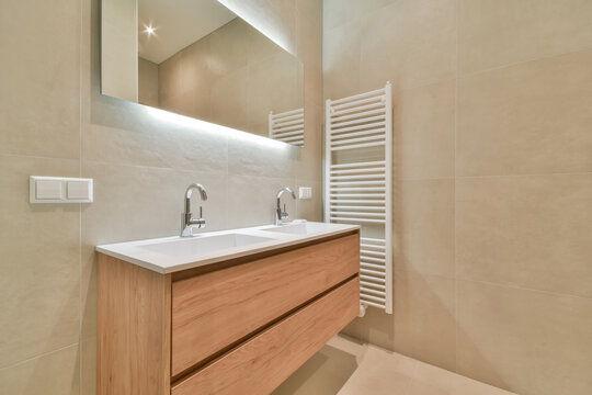 Modern bathroom with wooden vanity and sleek fixtures