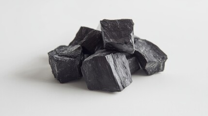Naklejka premium Black Coal Pieces on White Background.