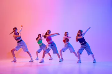 Wandcirkels Dansschool Dancers create mesmerizing flow of movement, capturing essence of rhythm and expression in neon light against gradient pink background. Concept of sport and hobby, motion. Dance school.  © Lustre Art Group 