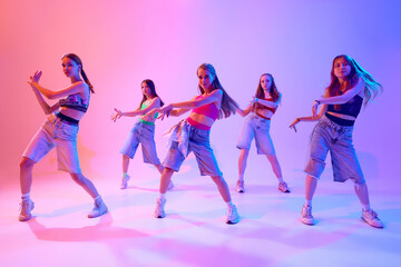 Group's unity shines through in this electric performance, where every move tells story in neon...
