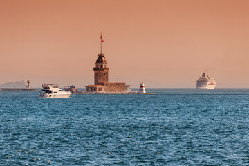 The iconic Maiden's Tower stands majestically on an islet in the Bosphorus, illuminated by a...