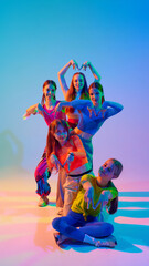Choreography shines as dancers perform with intensity and grace in neon light against gradient studio background. Concept of sport and hobby, childhood, friendship, motion. Dance lessons.