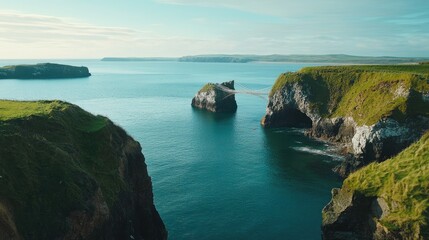 Fototapeta premium The tranquil Rope Bridge at Carrick-a-Rede, with ample space for copy in the coastal scenery