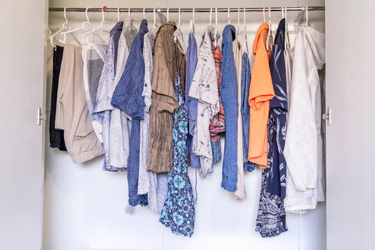 Woman sorting wardrobe for decluttering and sales