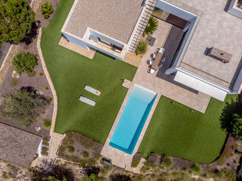 Modern luxury home with pool from aerial view