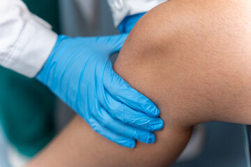 Physical therapist examining a patient's knee