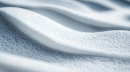 A close-up capture of fresh snow, showing intricate patterns and textures in the snow drift creating a serene and calm winter atmosphere perfect for seasonal displays and backgrounds.