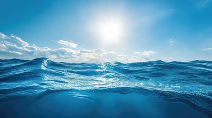 Deep blue ocean waves under a clear sky, sunlight reflecting on the water surface