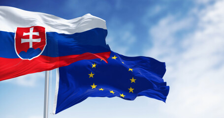 Close-up of Slovakia and the European Union flags waving on a clear day